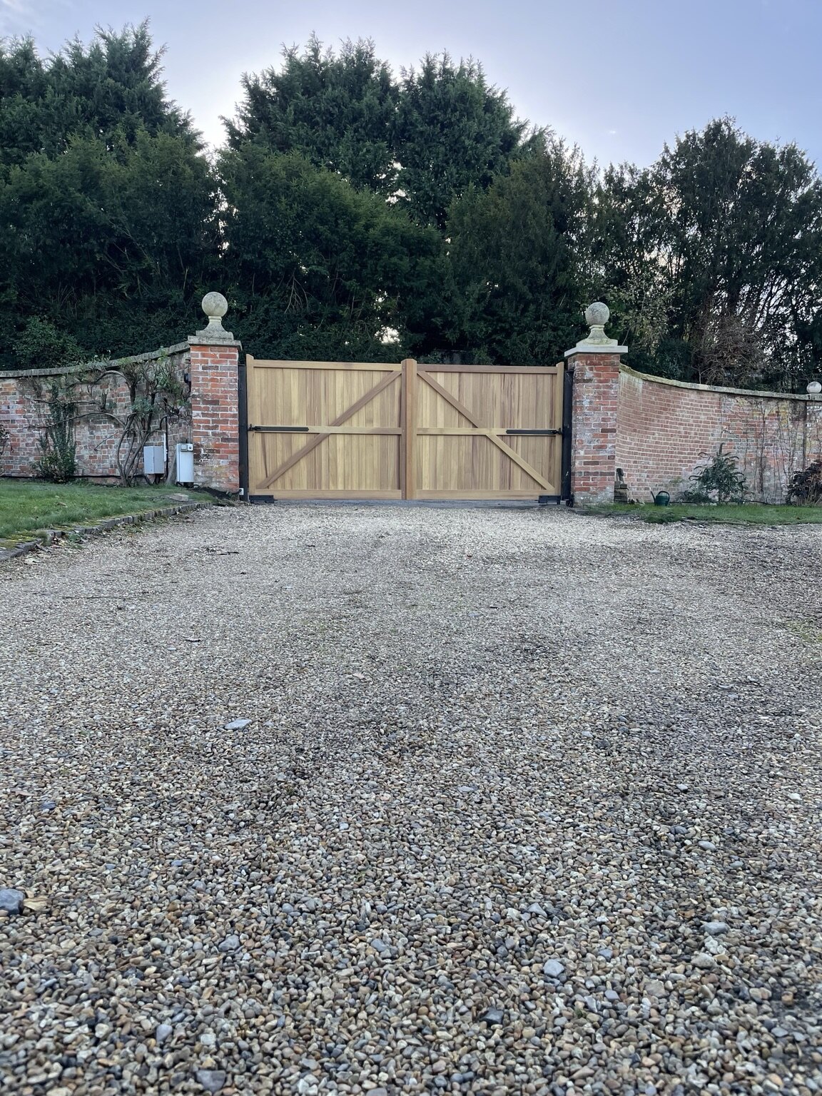 Braced timber driveway gates with powered gate operators viewed from inside
